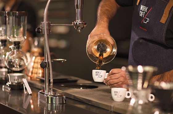 Work Café barista pouring coffee in a cup