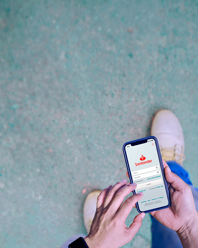 A customer logging into the Santander Mobile Banking App on their smartphone.