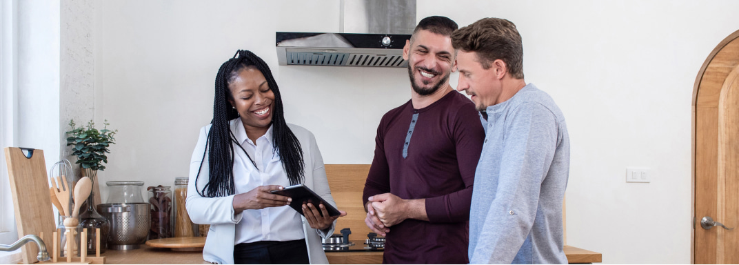 Young adults looking at tablet smiling