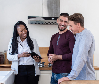 Young adults looking at tablet smiling
