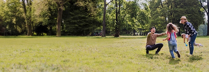 Image of family playing on a field