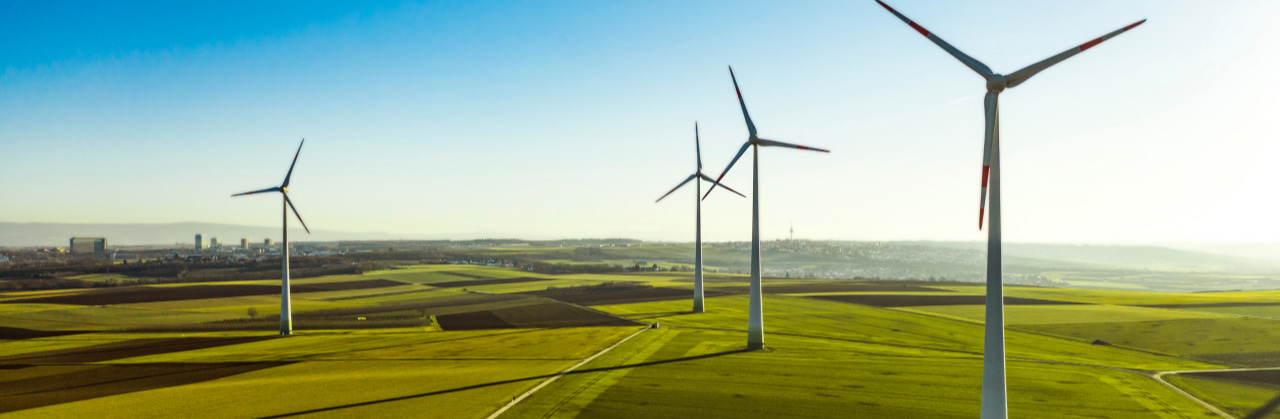 Wind turbines in a green field of grass