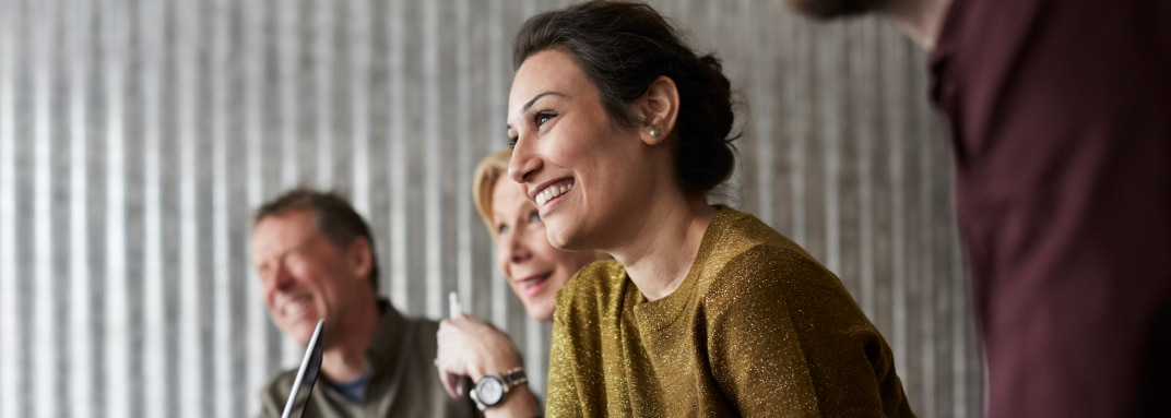 Woman smiling with coworkers