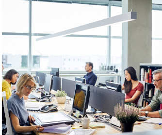 People working on computers in an open-office environment