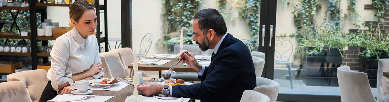 Woman and Man having Business Lunch in Restaurant