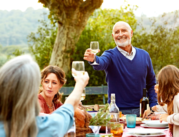 Man toasting at a gathering outdoors