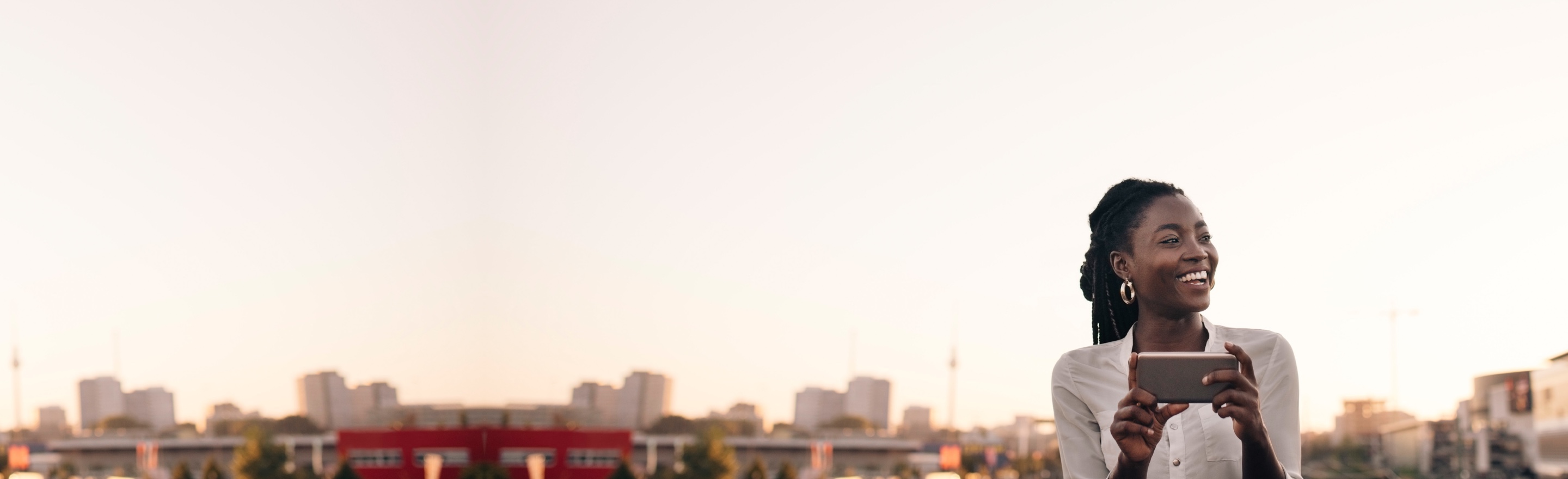 Woman sitting in her living room on her couch looking at her phone.