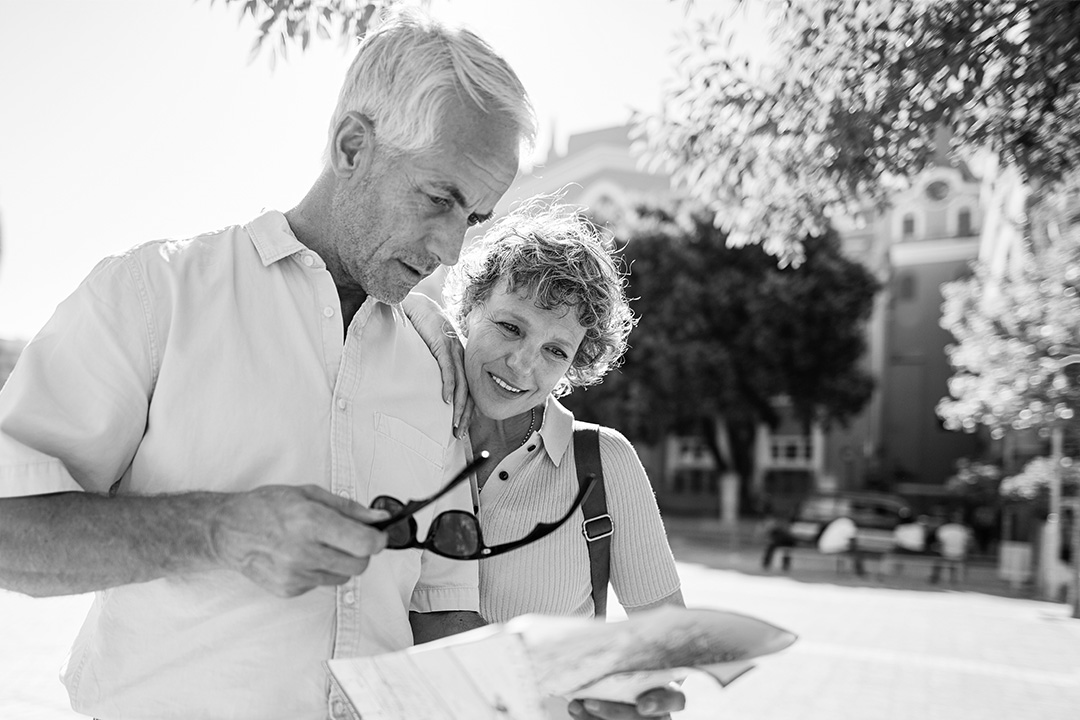 A man and woman looking at a map outdoors.