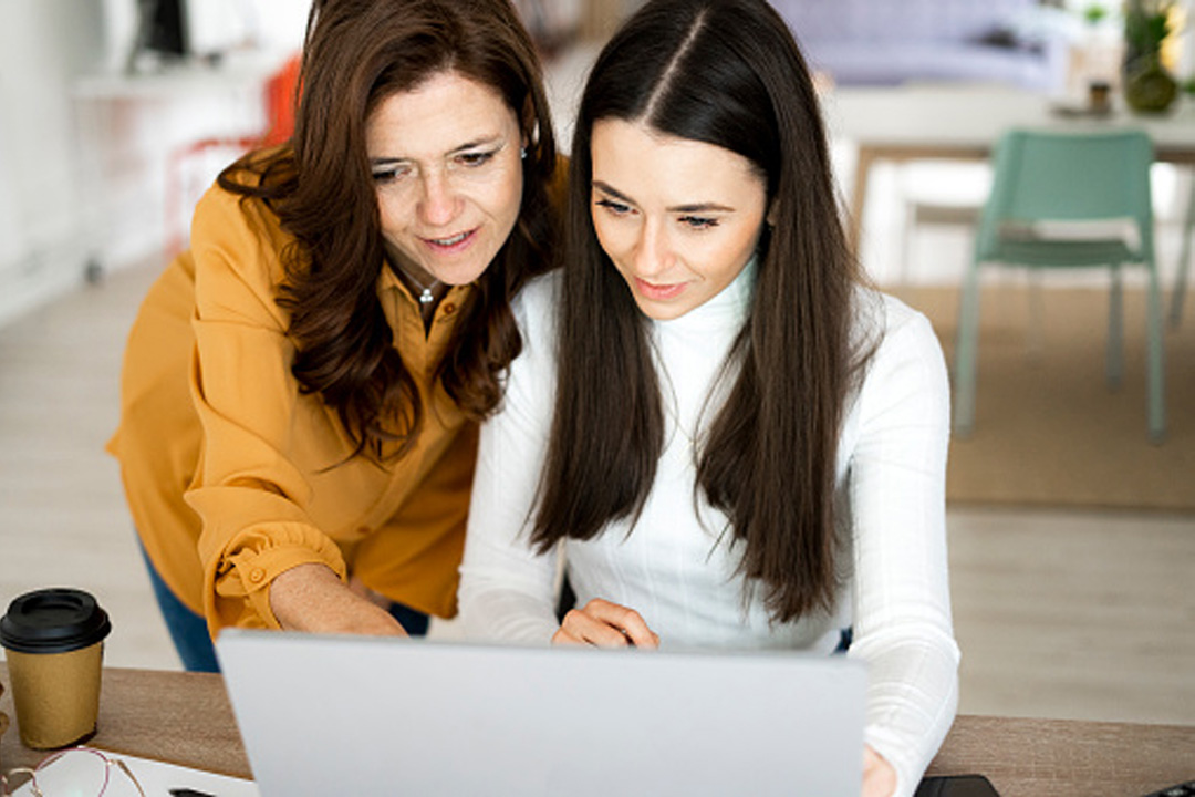 Mother and daughter looking at a laptop