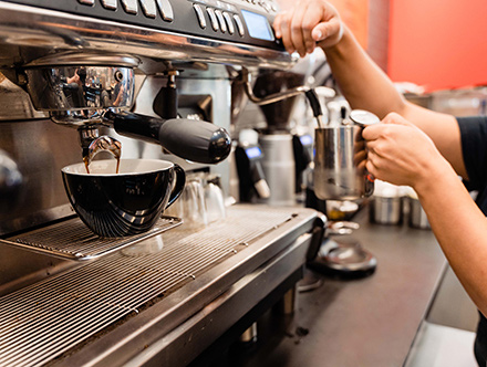 Espresso coffee machine with two coffee cups being filled