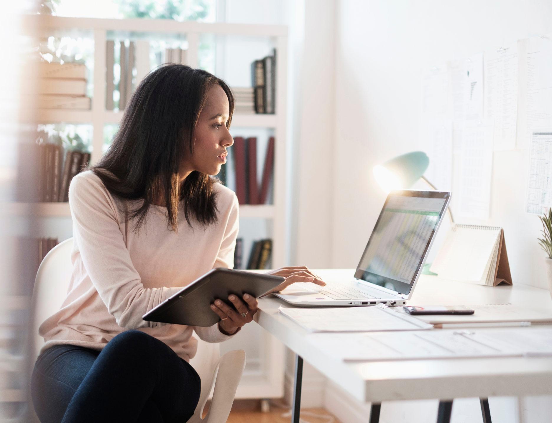 woman looking at laptop at desk