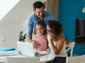 a man and a woman looking at a laptop