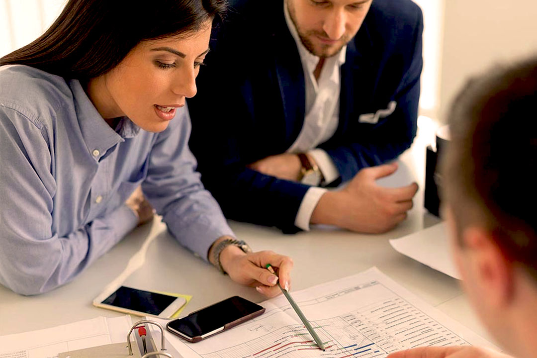 Group of professionals looking at financial documents